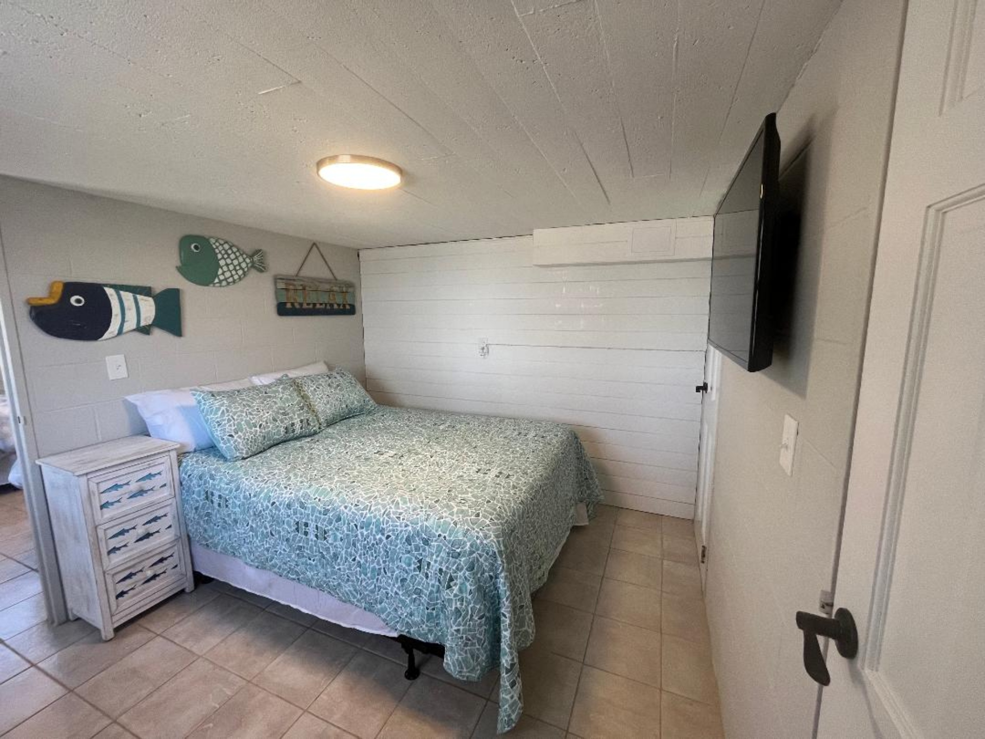 Downstairs bedroom with a queen bed