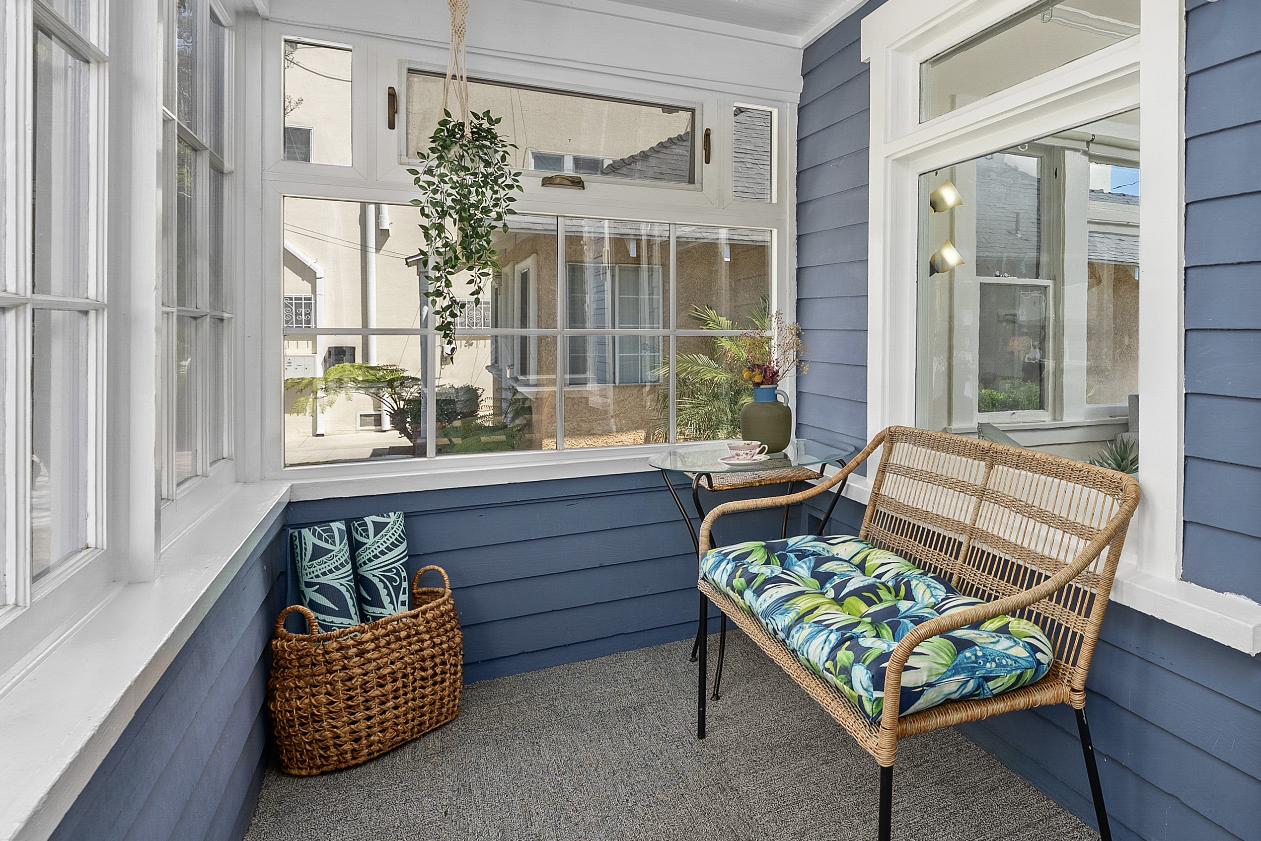 Cozy and bright sunroom with comfortable seating.