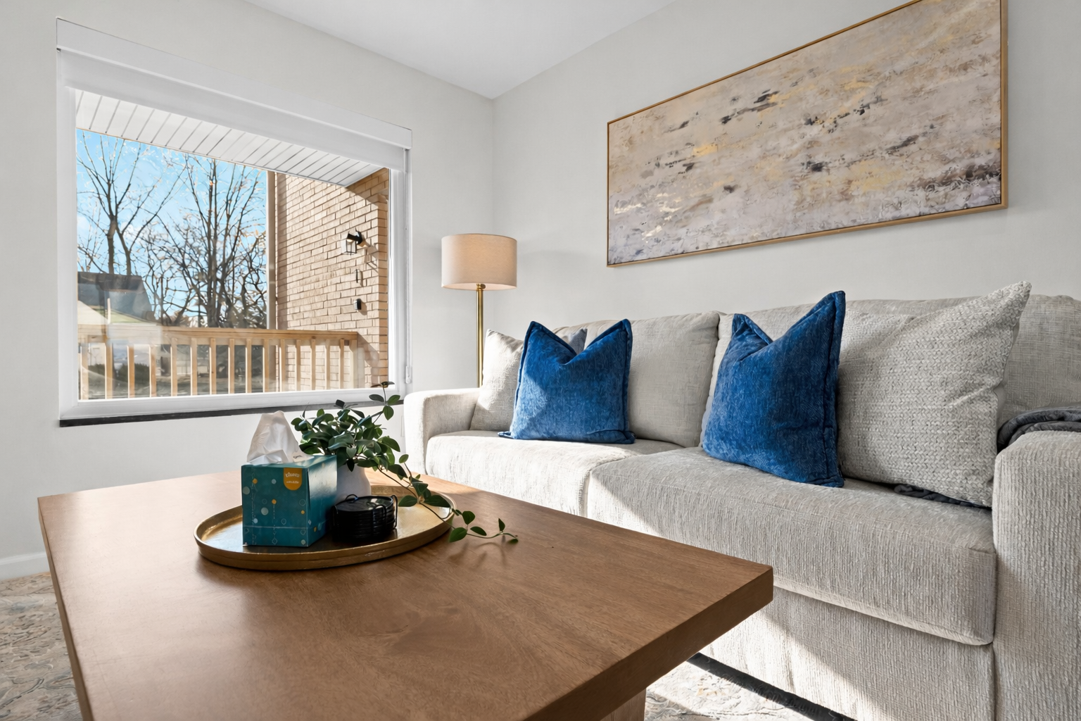 Sun-filled living space with plush sofa, cozy textures, and a welcoming layout—perfect for relaxing, reading, or enjoying a quiet evening in.