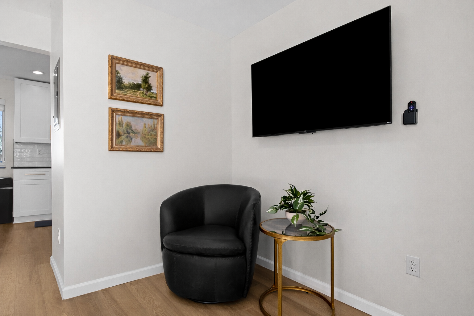 Cozy reading and lounge nook with plush seating, wall-mounted smart TV, and tasteful accents—perfect for unwinding after a day out.