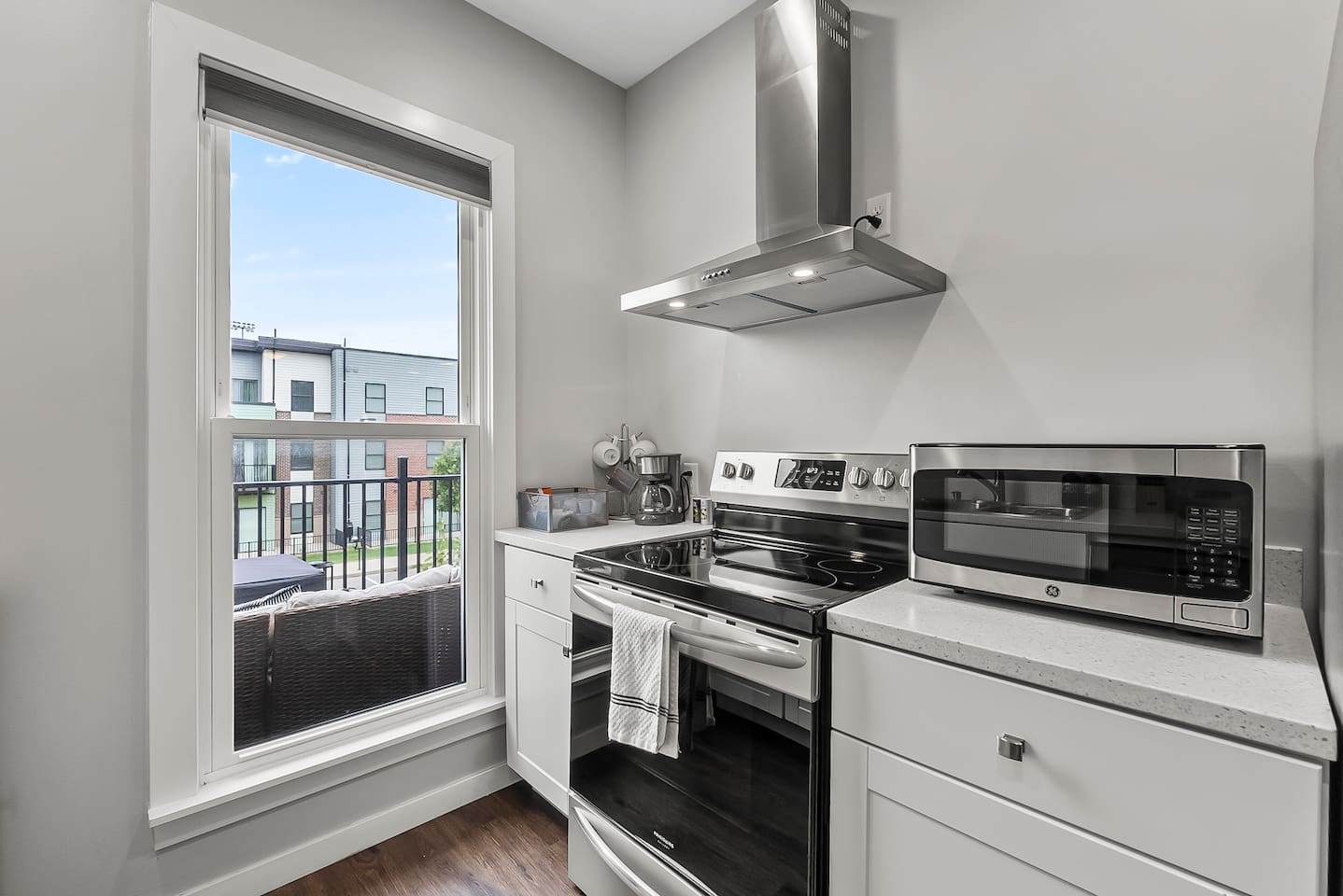 Stainless steel oven, range hood, and microwave ready for home-cooked meals.
