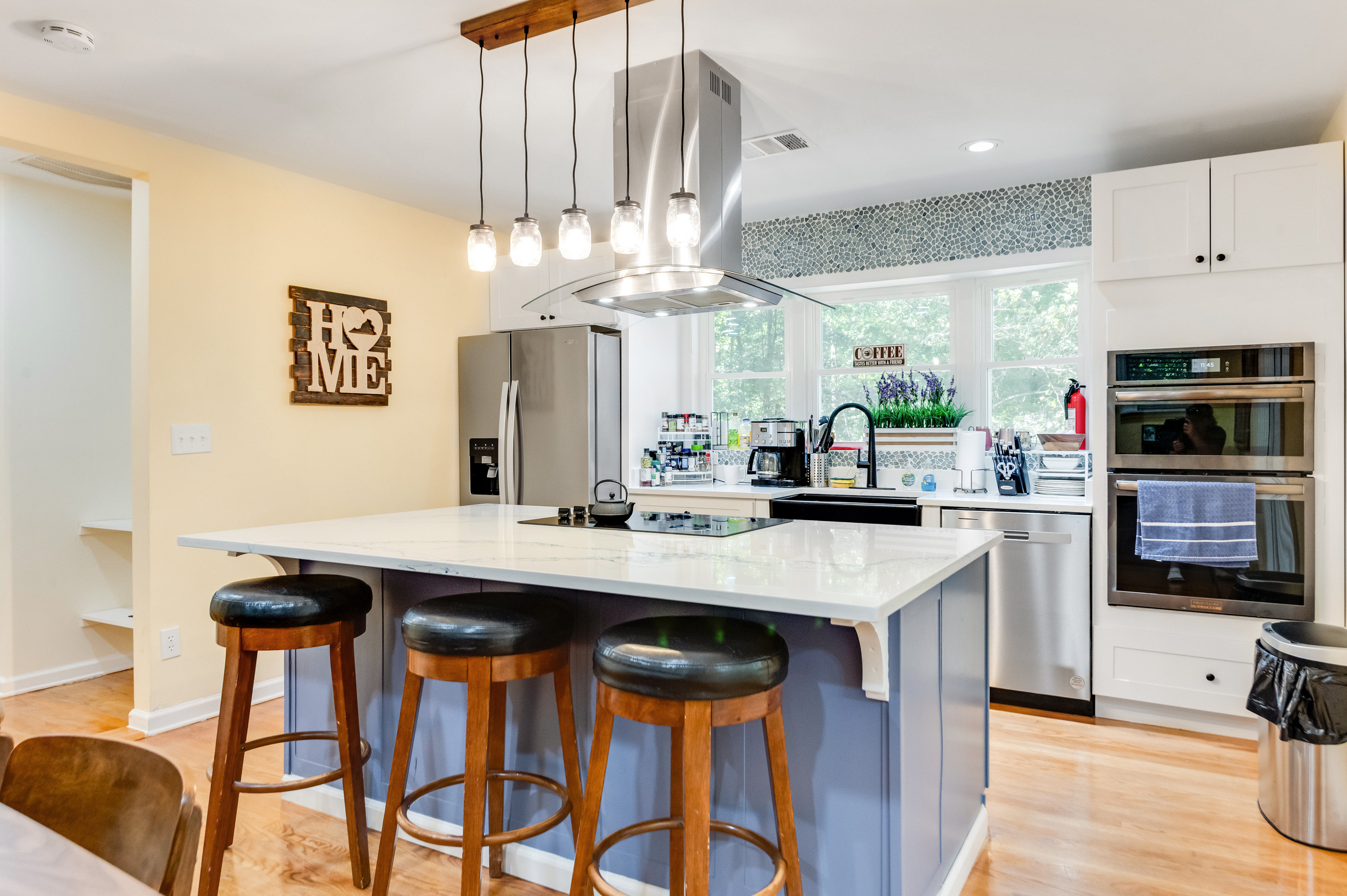 Kitchen: Bright and inviting space with modern appliances and stylish bar seating for culinary adventures!