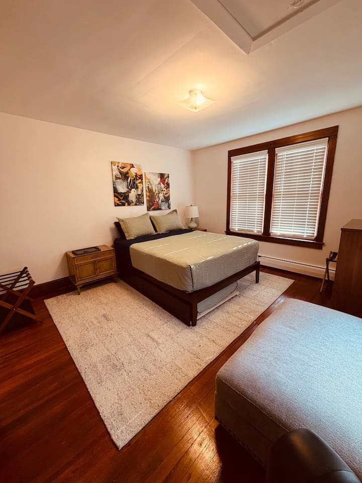 Primary bedroom with queen bed with twin trundle-soft linens, and natural light