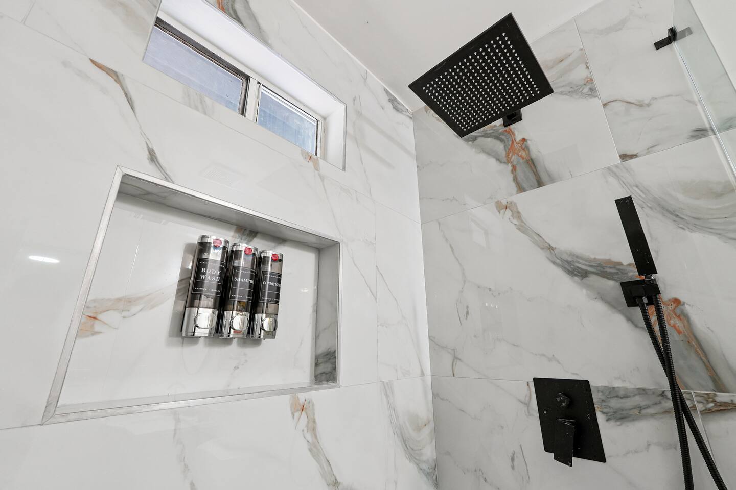 Full bathroom thoughtfully stocked with essentials including body wash, shampoo, conditioner, cotton pads, and Q-tips everything you need for a comfortable and refreshing stay.