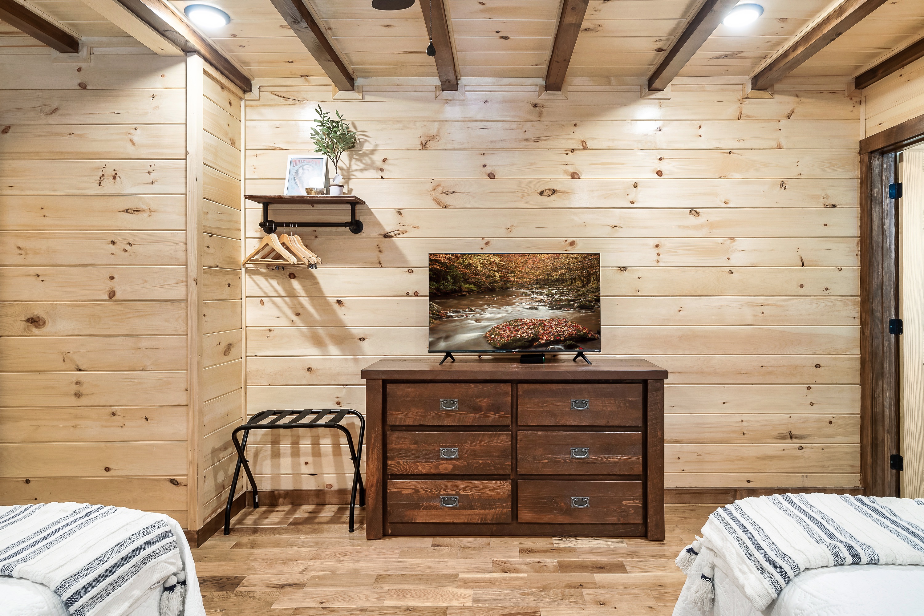 The Gold bedroom has a Smart TV and dresser