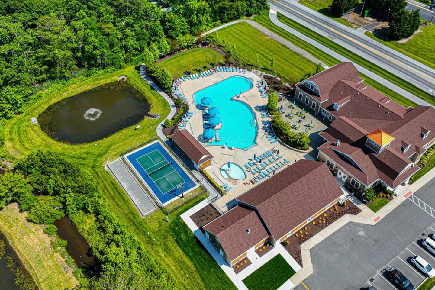 Discover a bird's-eye view of our clubhouse, outdoor amenities, and indoor pool. The indoor pool is an exclusive treat for our long-term guests, offering a tranquil and private retreat. ‍