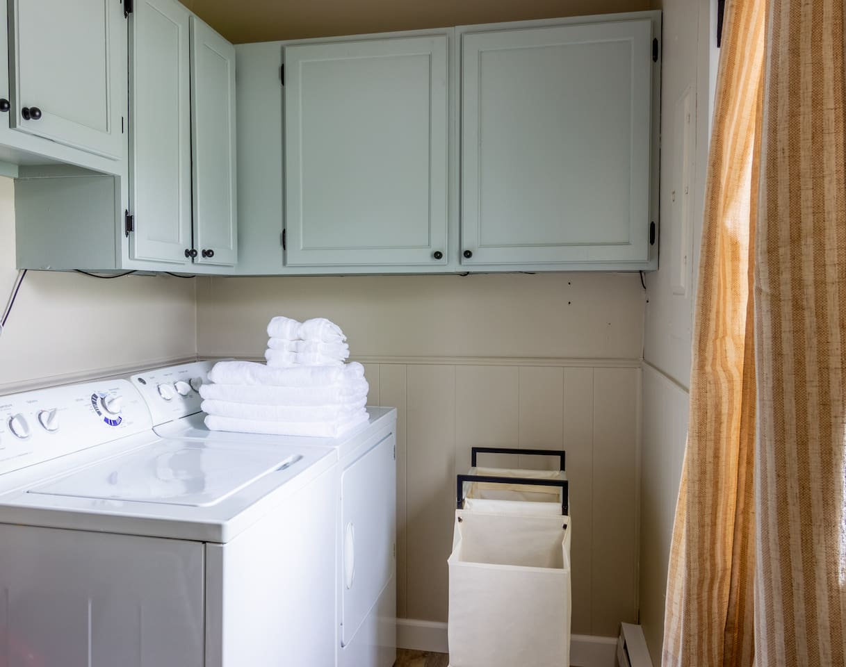 Fresh towels and a well-organized laundry corner keep longer stays simple.