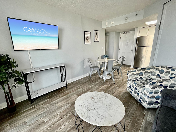 Indulge in beachfront bliss in our suite. Boasting a comfortable couch in the living area, providing the ultimate coastal comfort.