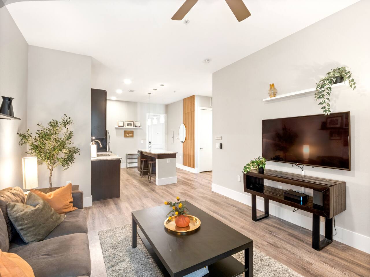 Comfortable living room with high ceilings and open layout. 50 in Smart TV for entertainment