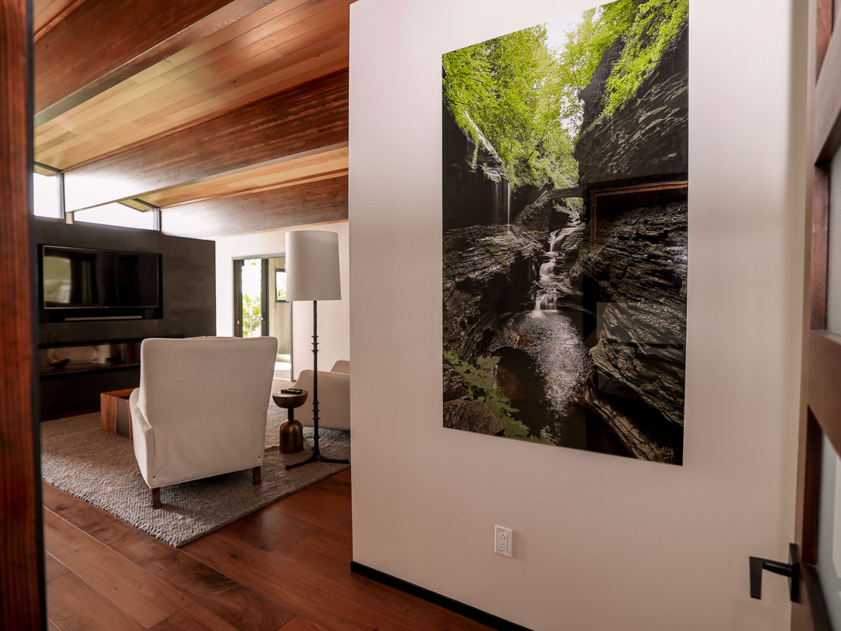 Primary Suite sitting room &mdash; recliners, linear fireplace, morning bar