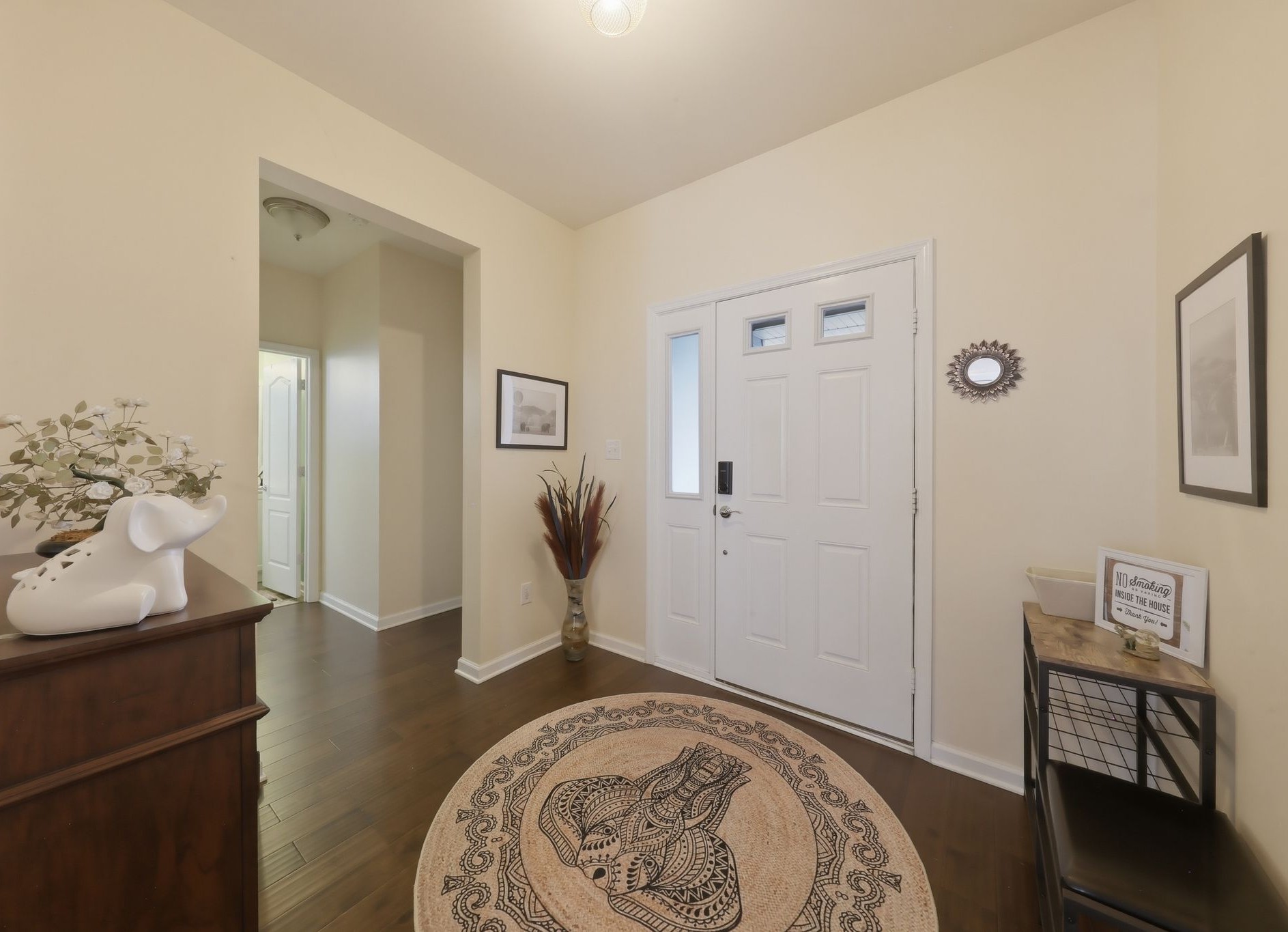 Large foyer equipped with shoe storage, a large coat closet and bench for managing shoes and kids!