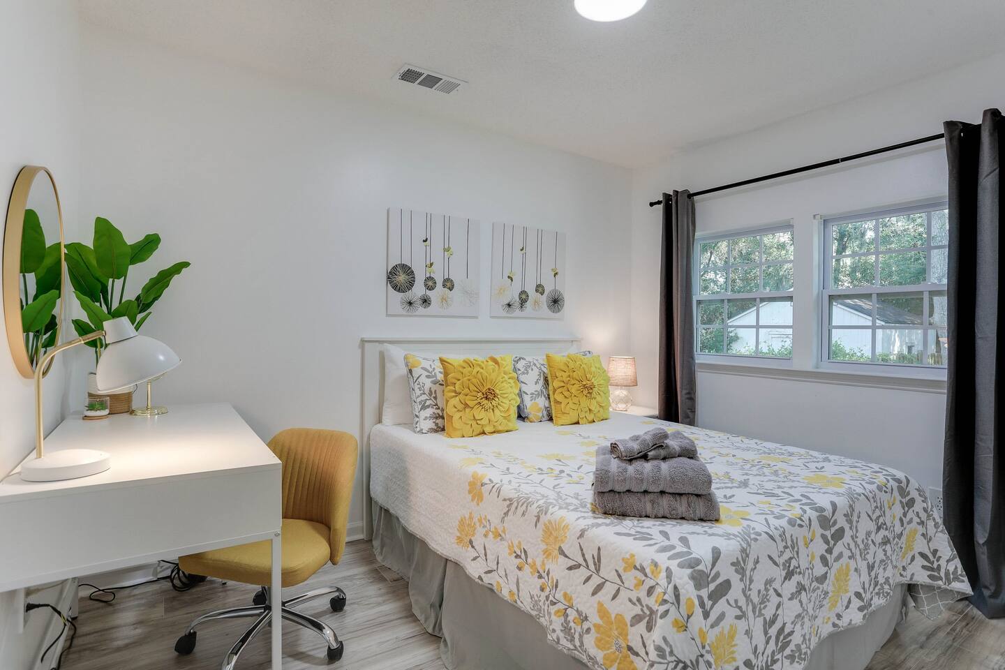 Unwind in the third bedroom, featuring a comfortable queen bed, a convenient desk for work or planning your day, and extra pillows for added comfort.