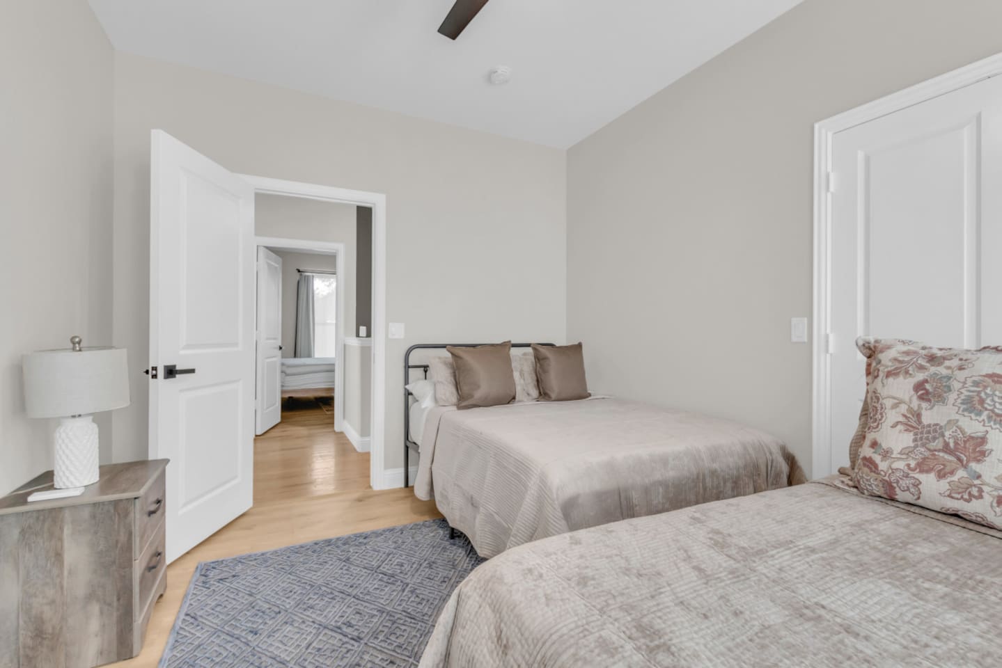 Guest room with 2 full beds and plenty of natural light.