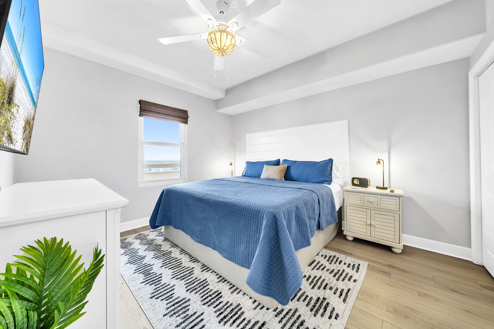 A serene second king suite with soft coastal touches and its own en suite bath—perfect for relaxing after a day at the beach.