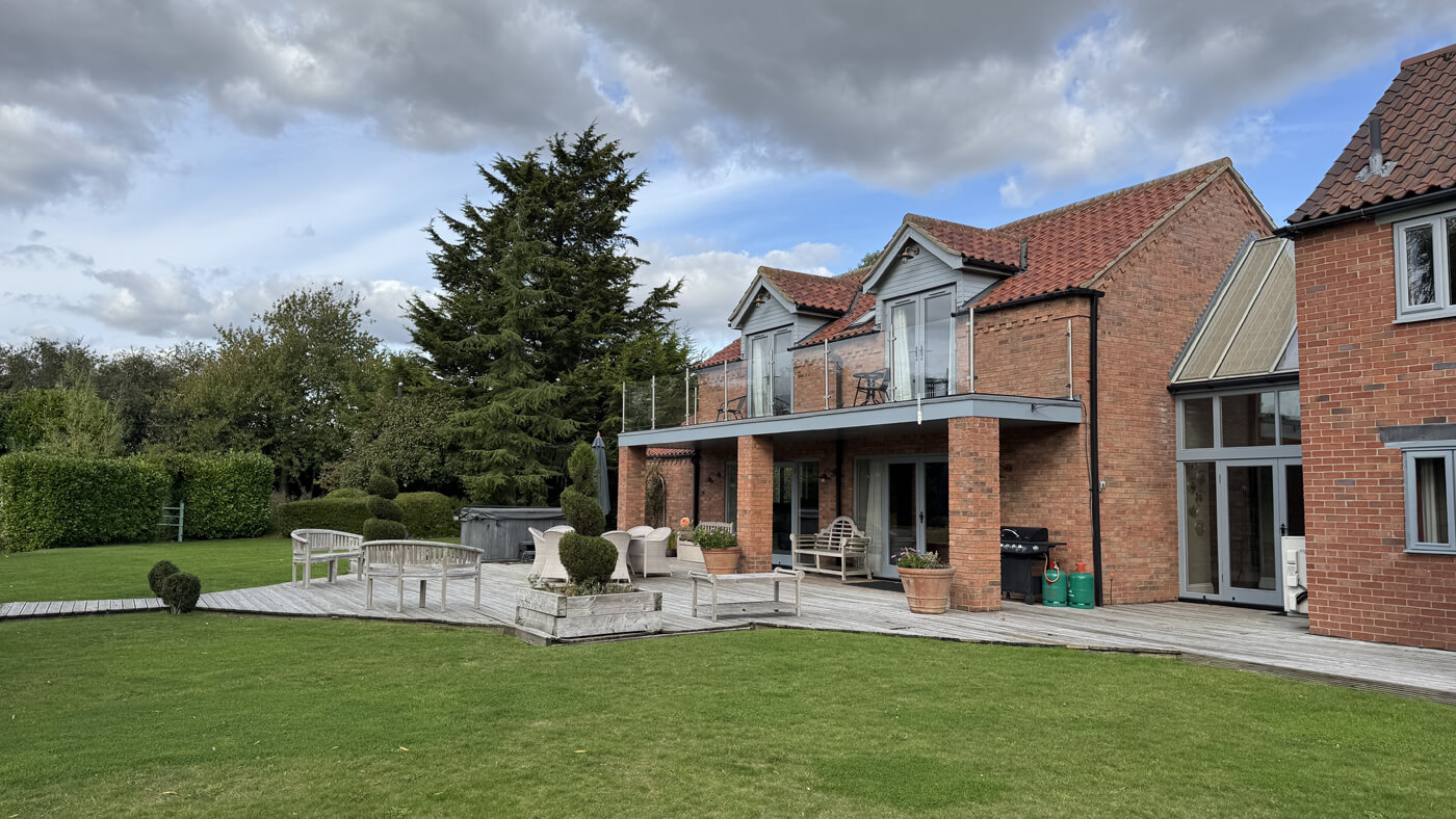 Main house rear garden to decking and Grouse bedroom balcony