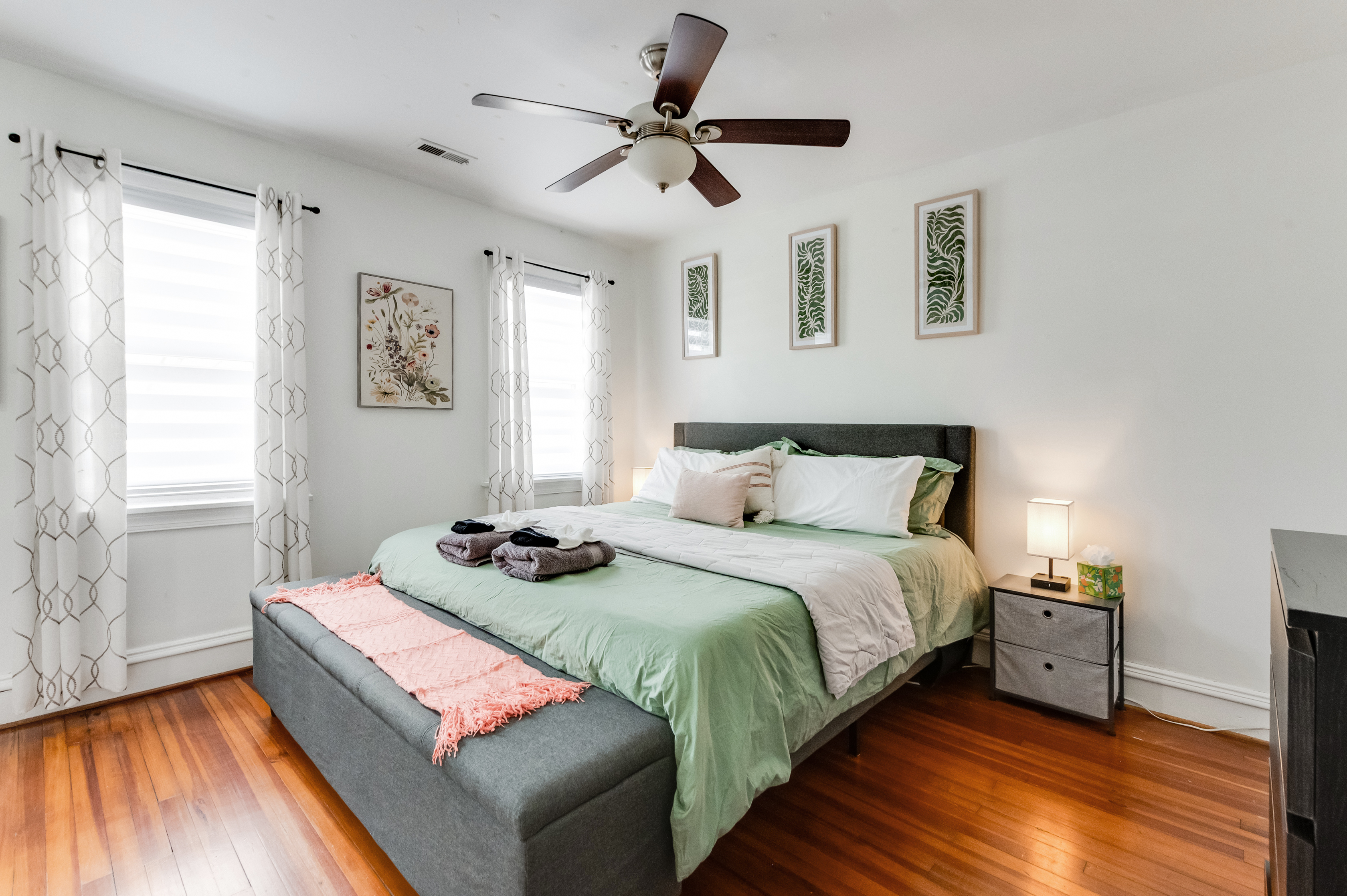 King Bedroom 2: Bright and inviting space with lush decor and warm wooden floors for relaxation!