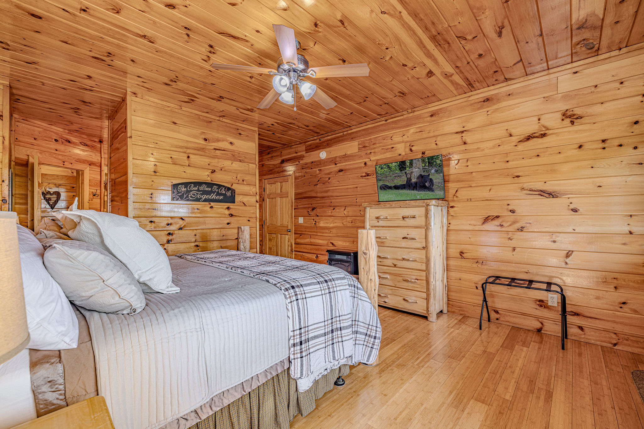Roomy primary king suite with private deck access, cozy electric fireplace, and smart TV with Roku—your perfect year-round retreat.