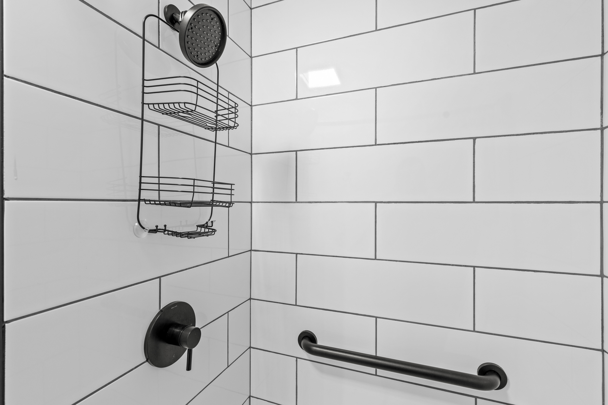 The beautifully updated walk-in shower features modern finishes and plenty of space to refresh after a day outdoors.