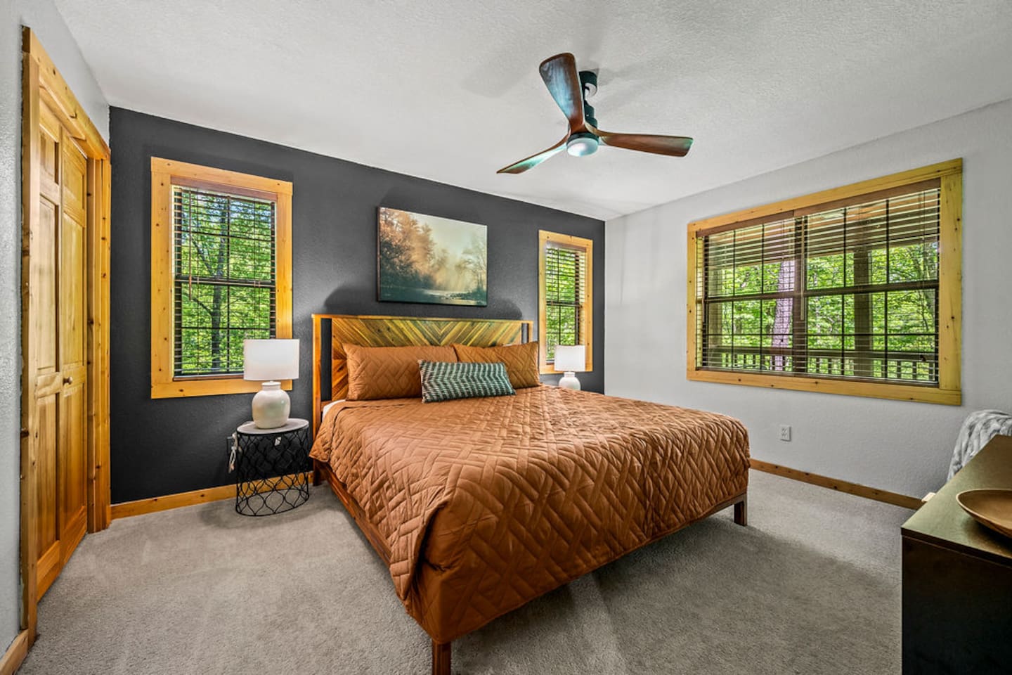 Main floor king bedroom with TV and bathroom.