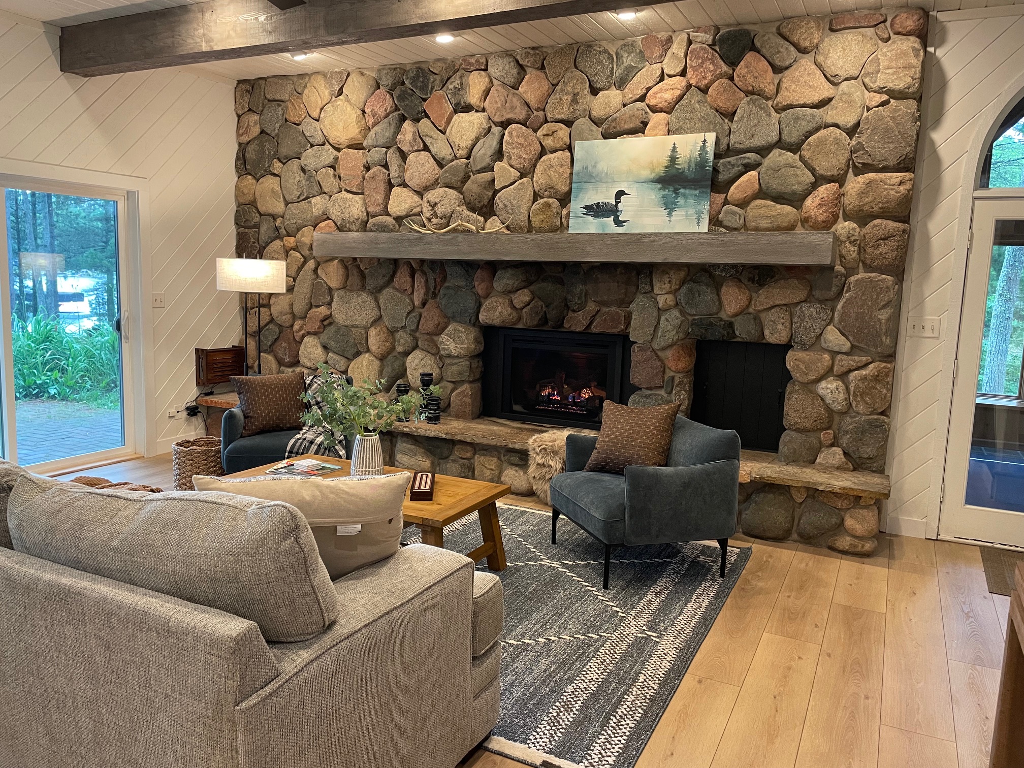 A beautiful fieldstone gas fireplace anchors the living room