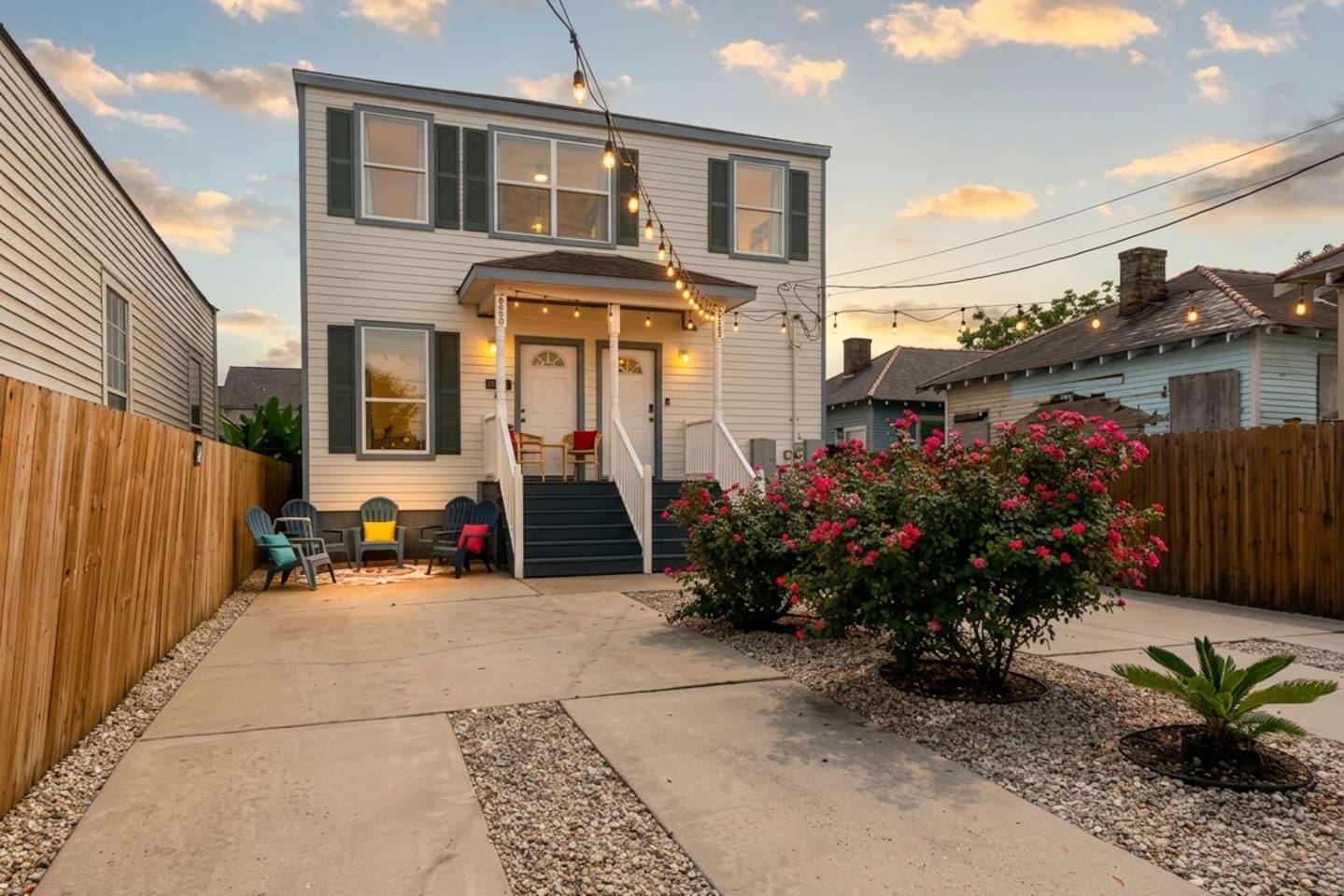 This house is inviting inside and out - enjoy the private driveway parking (fenced), plus two cozy seating areas in front of the house! 