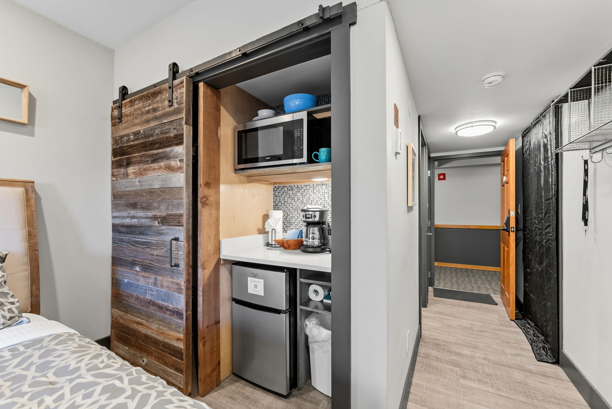 Closet and kitchenette with microwave, coffee maker and mini fridge