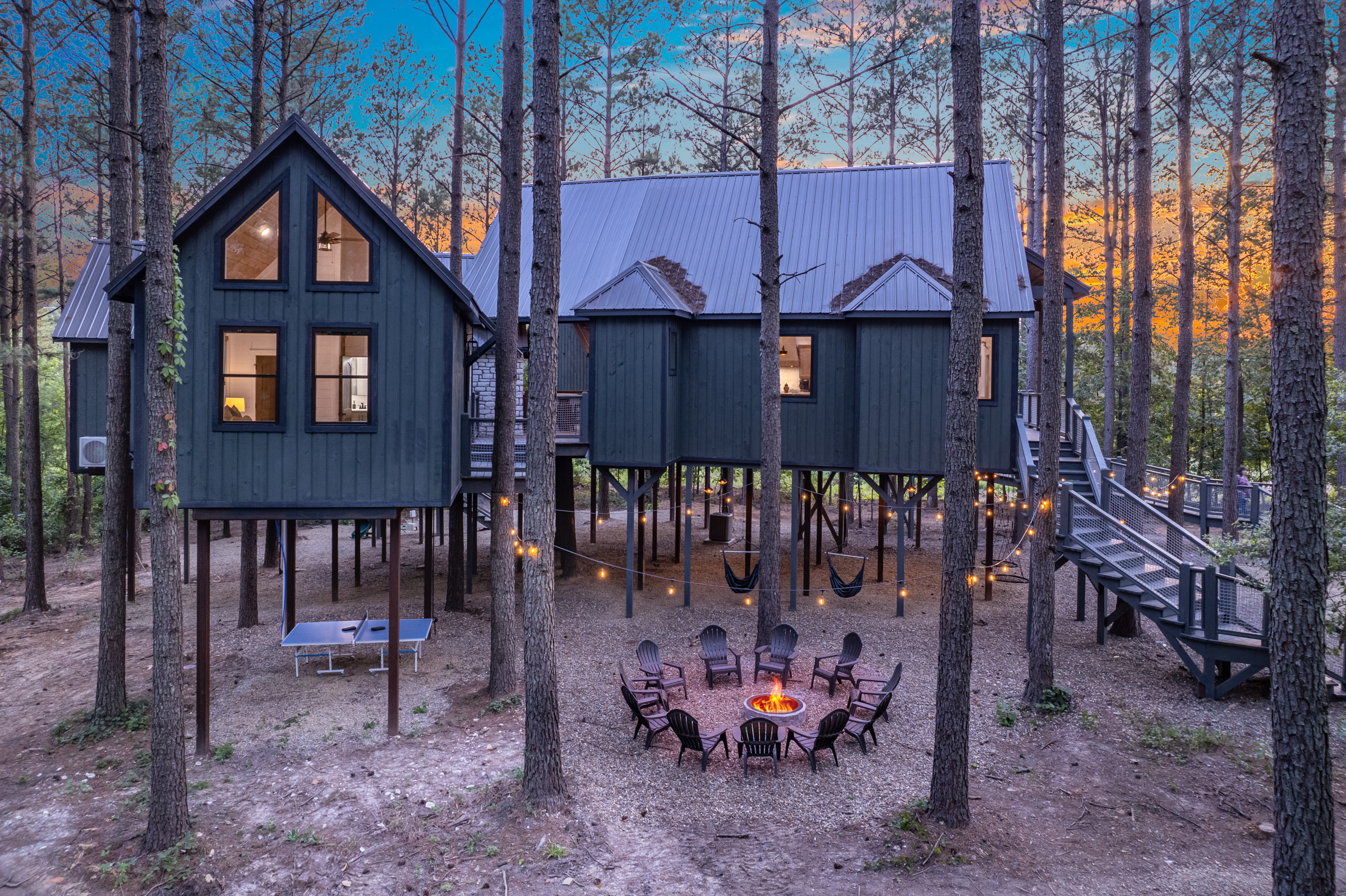 The outdoor space has something for everyone – a cozy fireplace, a slide off the deck, disc swings, hammock swings, outdoor ping pong, corn hole, and a firepit.