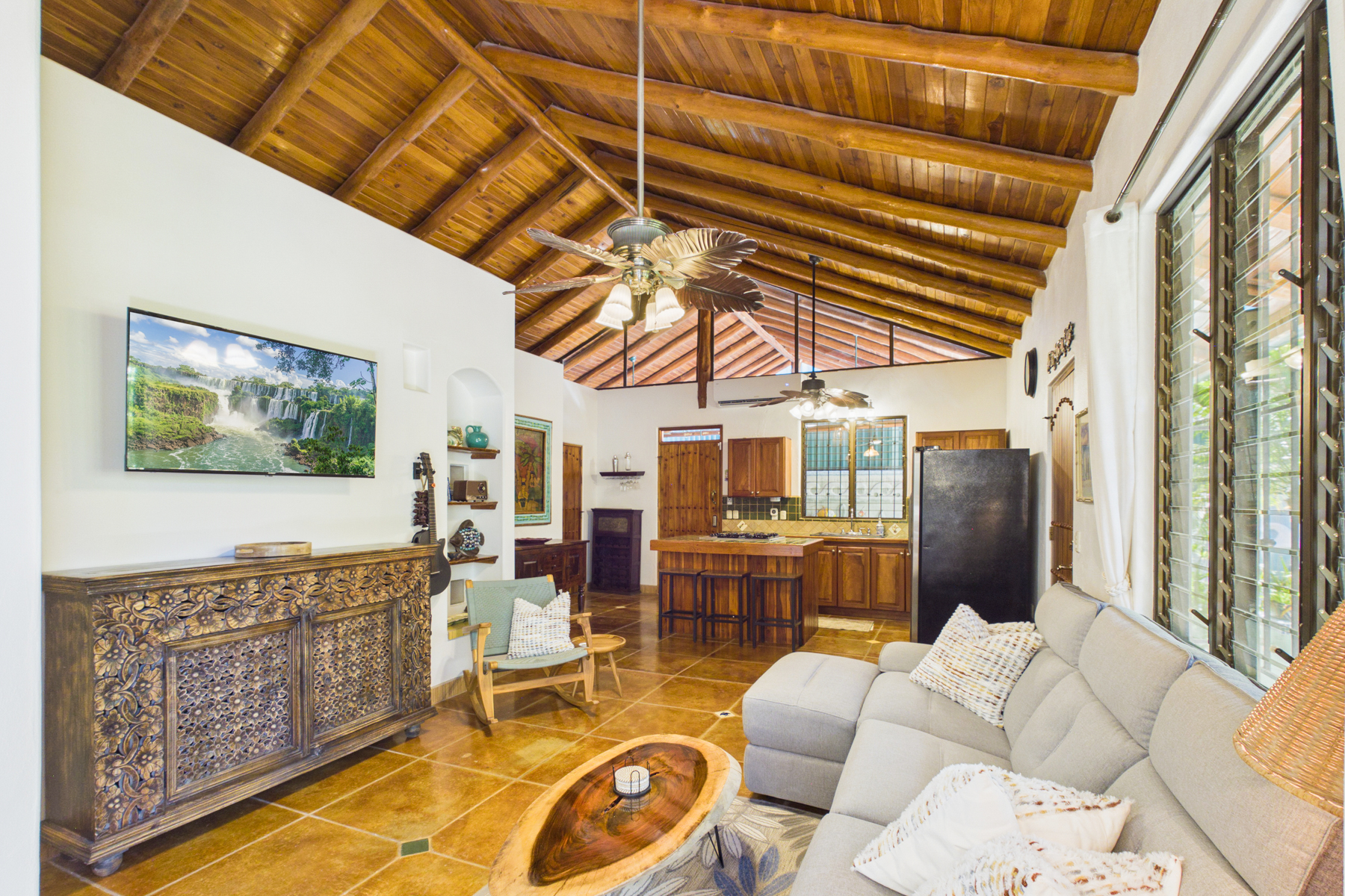 Brand new living room furniture.  Open ceiling and Open Living room/Kitchen.  Smart TV in living room.  Bluetooth speaker in living room. Kitchen island seating.  