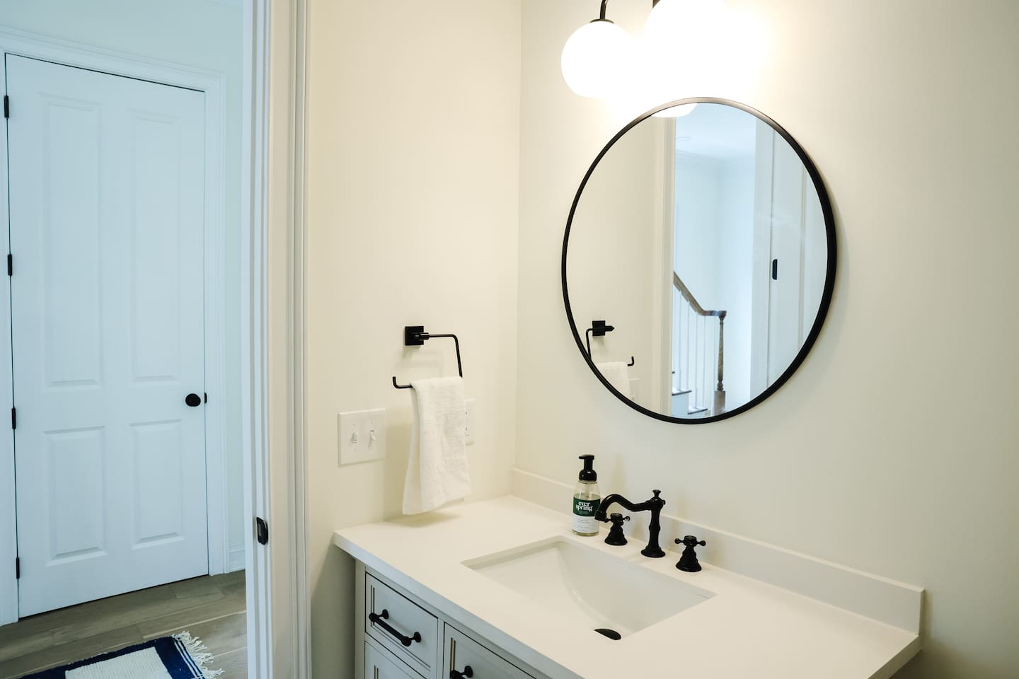 The downstairs full bathroom is just down the hall from the living area featuring a private entrance to the downstairs bedroom.