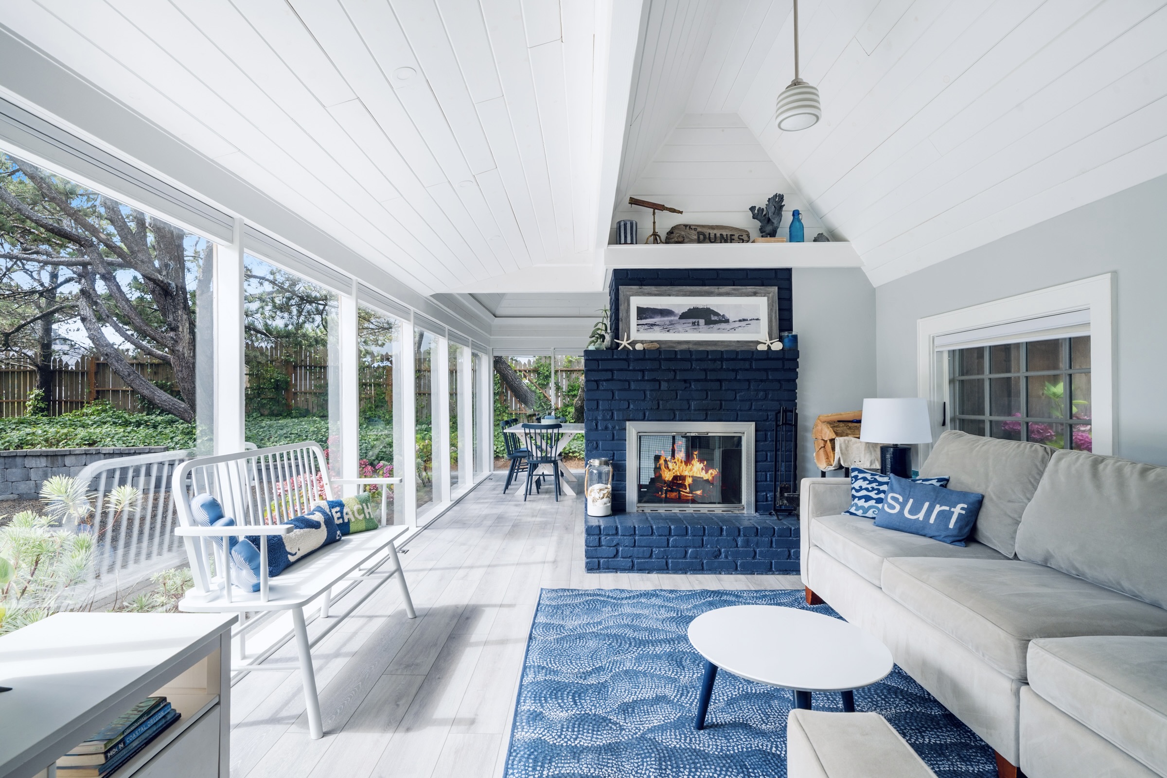 LIVING ROOM  double sided wood-burning fireplace & wall of windows 