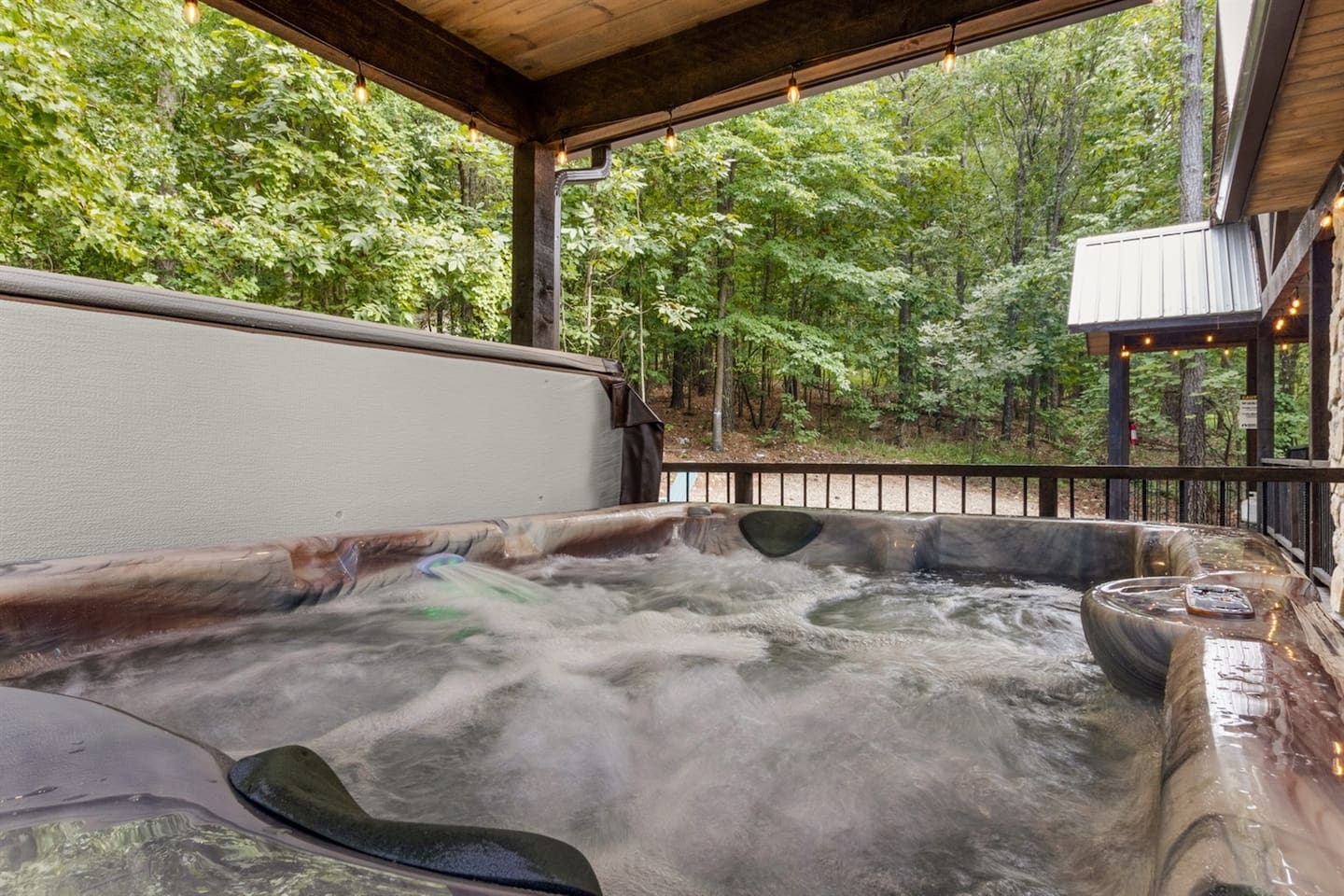 Relax and unwind in the bubbling hot tub, surrounded by peaceful woodland views.