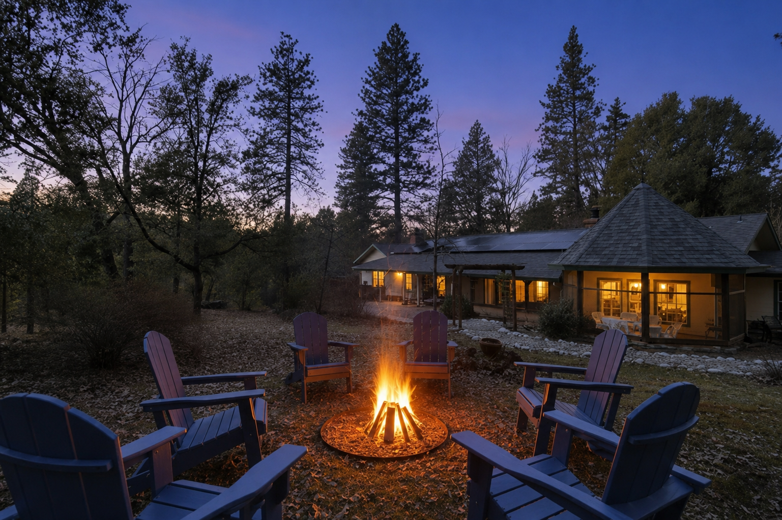 Fire pit seating at dusk with chairs, wooded surroundings, and warm cabin views for relaxing evenings outside.