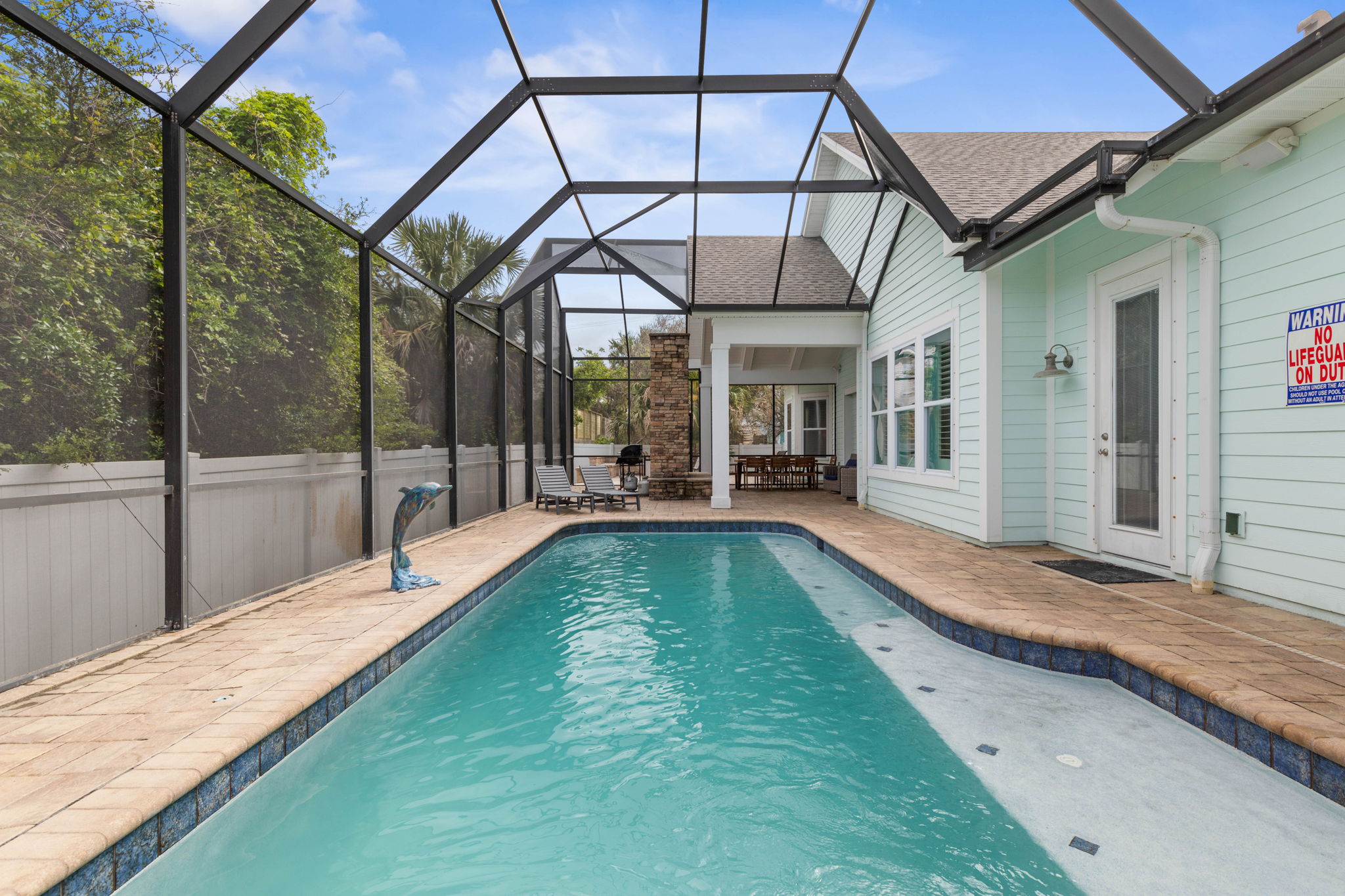 Slip into the pool after a sun-soaked beach day, share dinner under the covered lanai, and end the evening by the outdoor fireplace—your private screened retreat makes every moment feel easy, cozy, and unmistakably coastal.
