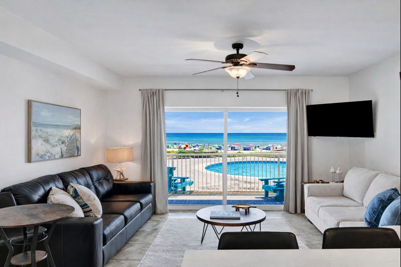 Living room with sleeper sofa, a 2nd sofa, smart TV, ceiling fan and balcony access