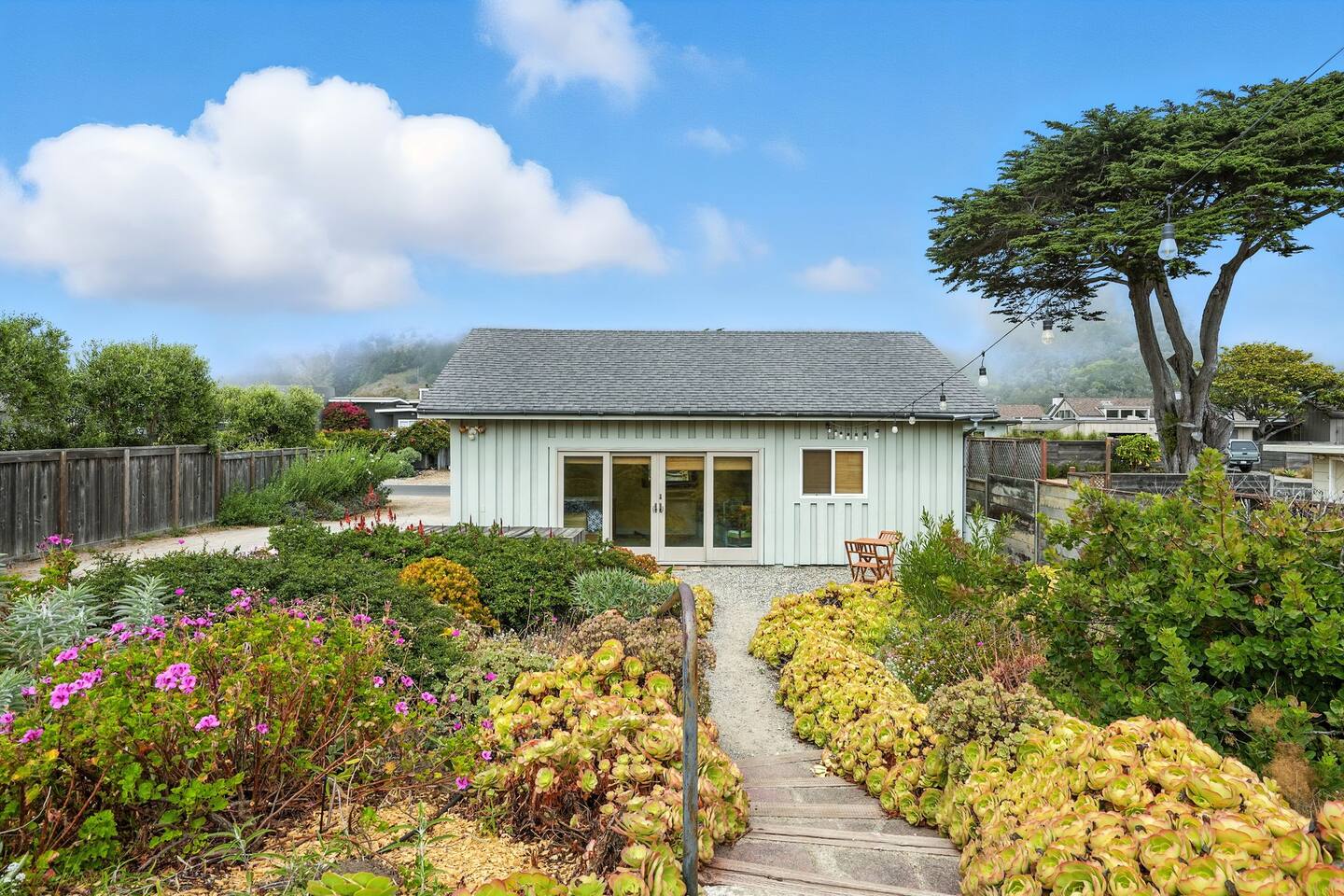 Front garden walkway leading to a coastal cottage.
