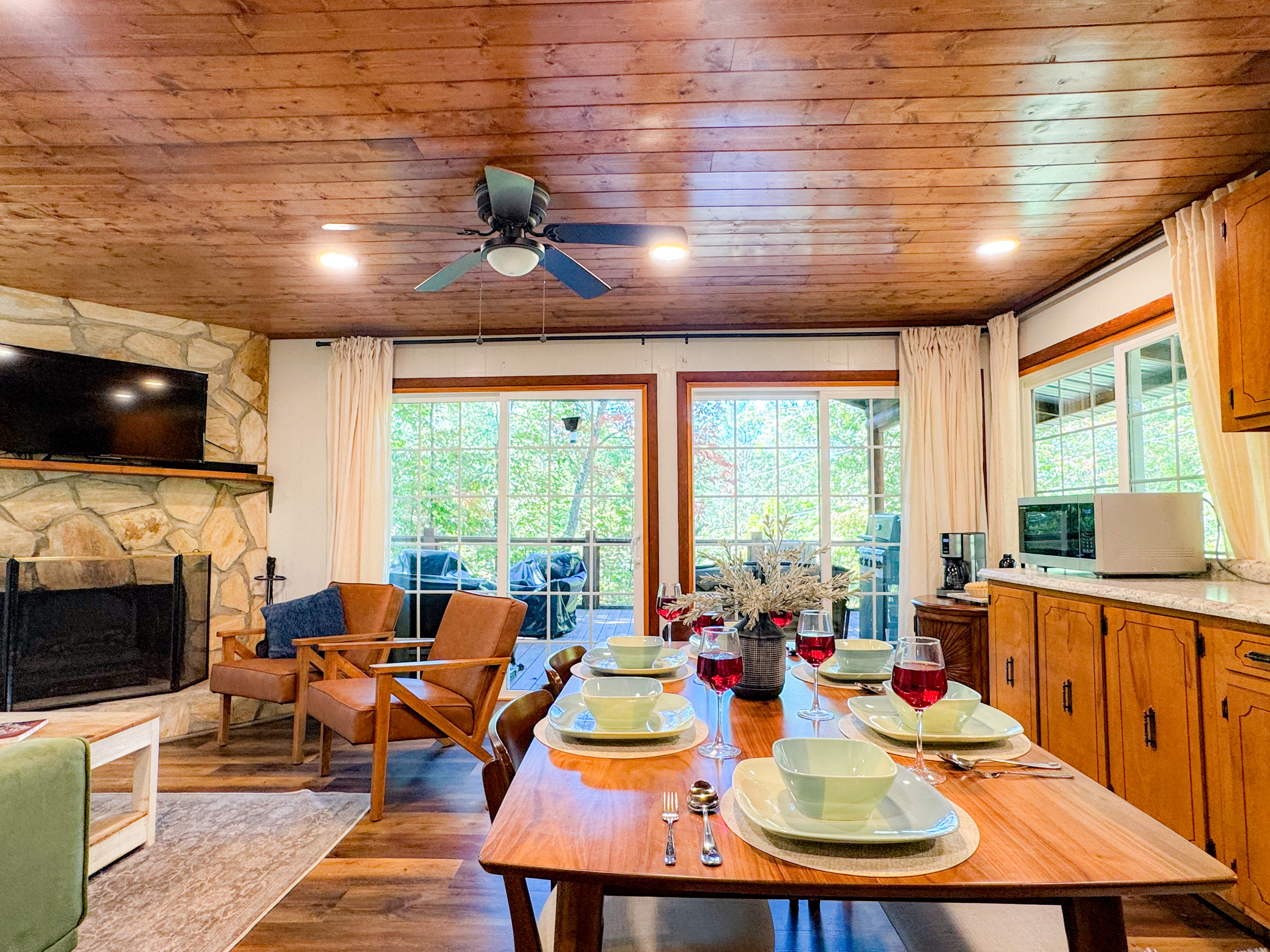 Our dining area features seating for 6. The open concept kitchen, dining, and living room area all overlook the woodlands providing a tree house feel from inside!