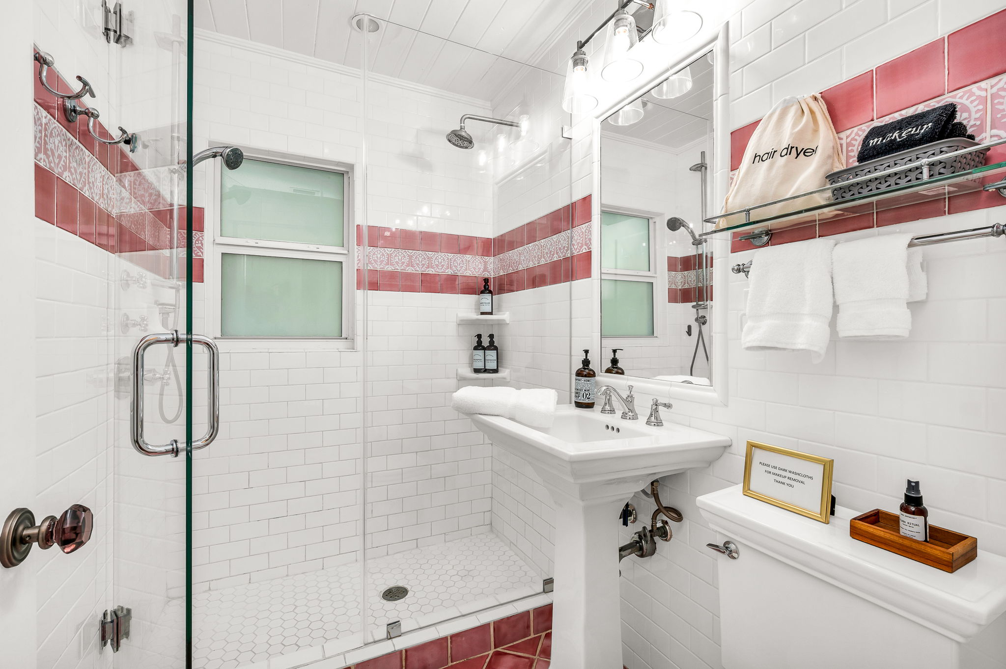 Full bathroom #2: Newly upgraded, charming guest bathroom featuring dual shower heads and stylish updated light fixtures. Conveniently shared between two bedrooms, this space combines functionality with vintage-inspired tilework.