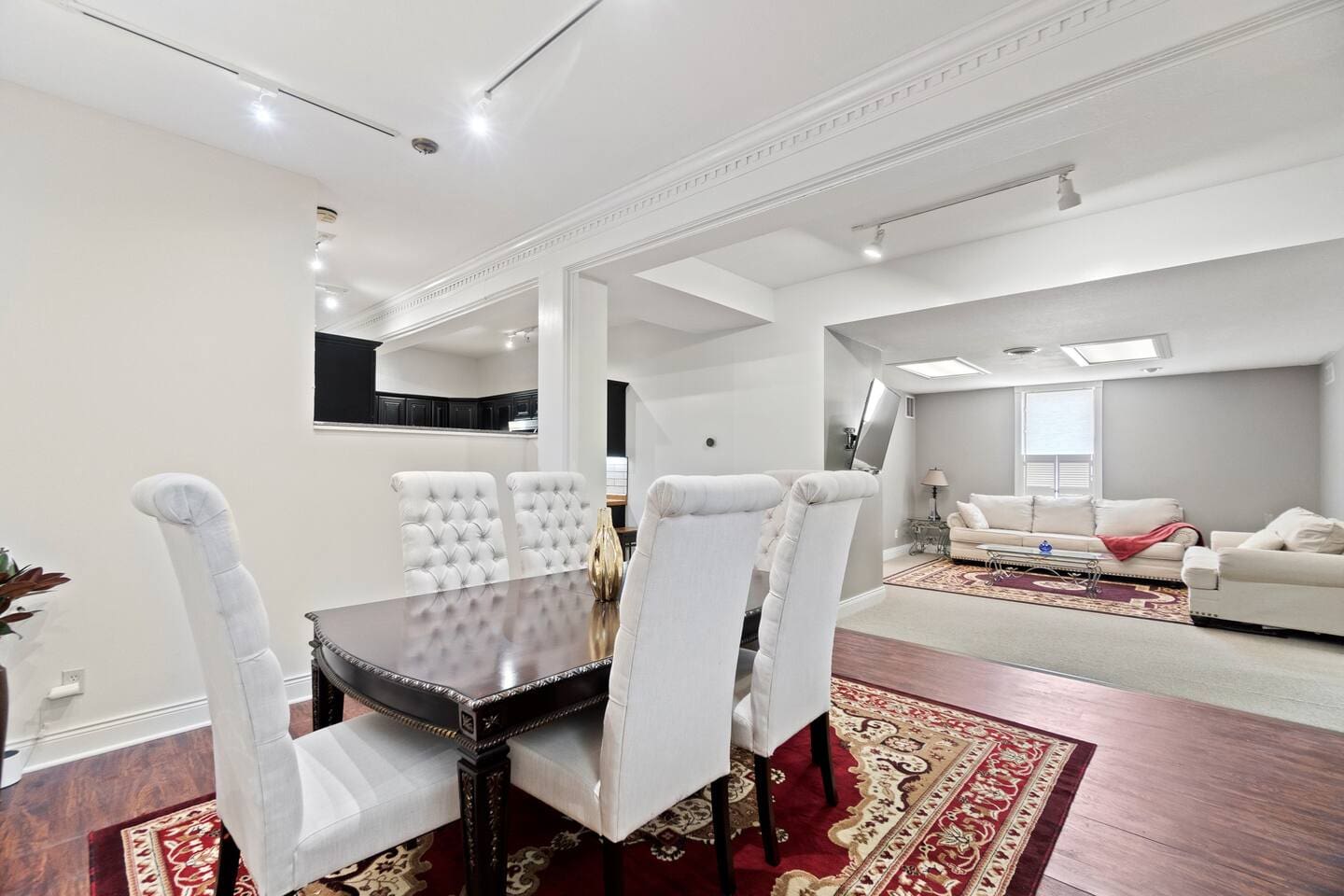 Elegant dining table featuring sleek white chairs, offering a chic and sophisticated setting for meals and gatherings.