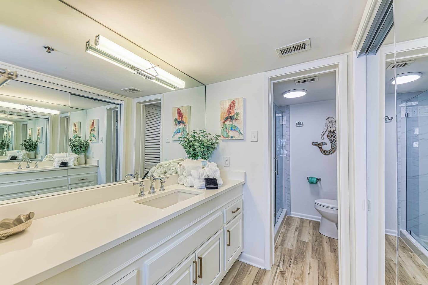 Bathroom Oasis: Bright and airy retreat with modern fixtures and stylish ocean-inspired decor!