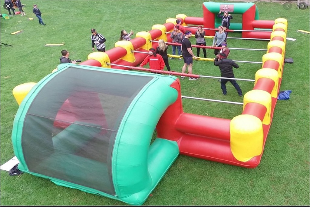 Life-size human foosball&mdash;team up for some unforgettable fun