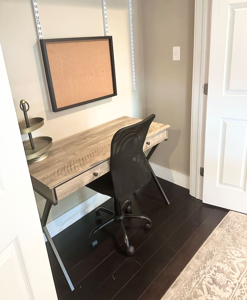 Tucked away for privacy, this dedicated workstation features a rustic wooden desk, an ergonomic mesh chair, and a handy corkboard. It is the perfect nook for catching up on emails or planning your daily itinerary before heading out to the sand.