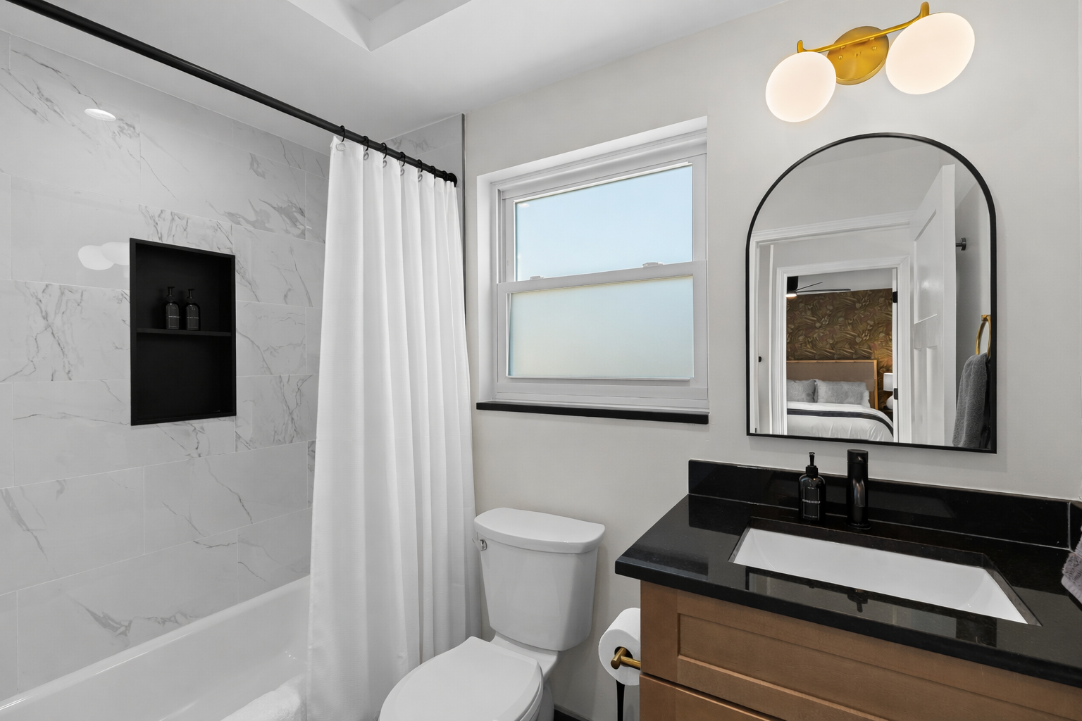 Bright, modern bathroom with a sleek vanity, spa-like shower, and soft natural light—designed for a refreshing and comfortable stay.