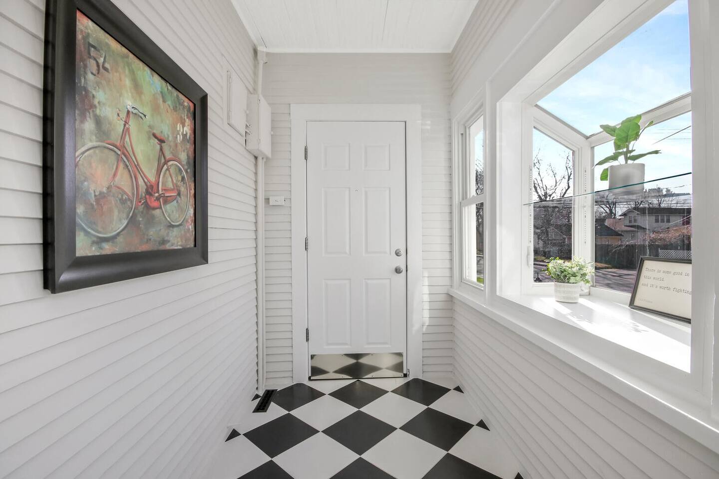 Sunny entraway makes a great drop point for shoes and bags and coats.