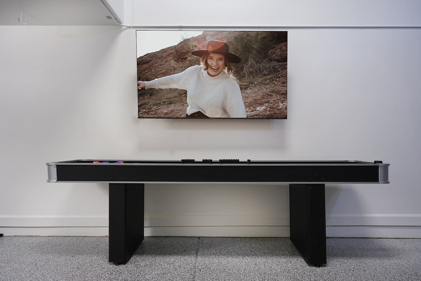 Air conditioned and heated garage space includes tons of games like foosball, air hockey, and shuffleboard. Watch TV on the large LoveSac couch if you'd like.