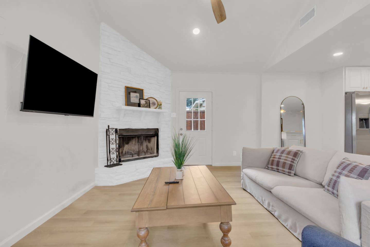 Spacious private living room featuring an indoor fireplace and comfortable seating—perfect for unwinding after a day at Grandscape or Topgolf.