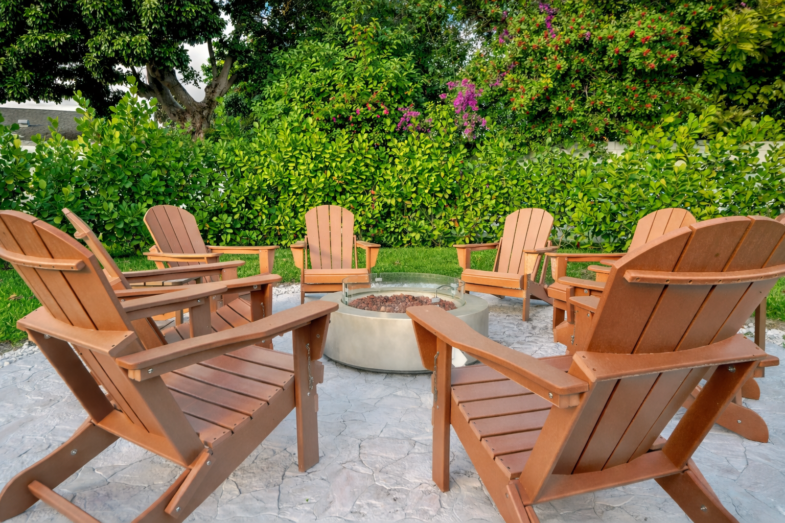 Gas-powered fire pit surrounded by Adirondack chairs in a private, family-friendly Palm Beach backyard.