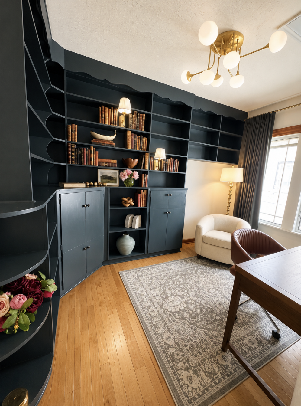 Main floor office with built-in shelving, comfortable seating, and a dedicated workspace. This flexible room can be converted to an extra twin bedroom upon request, offering added sleeping space while maintaining a quiet retreat.