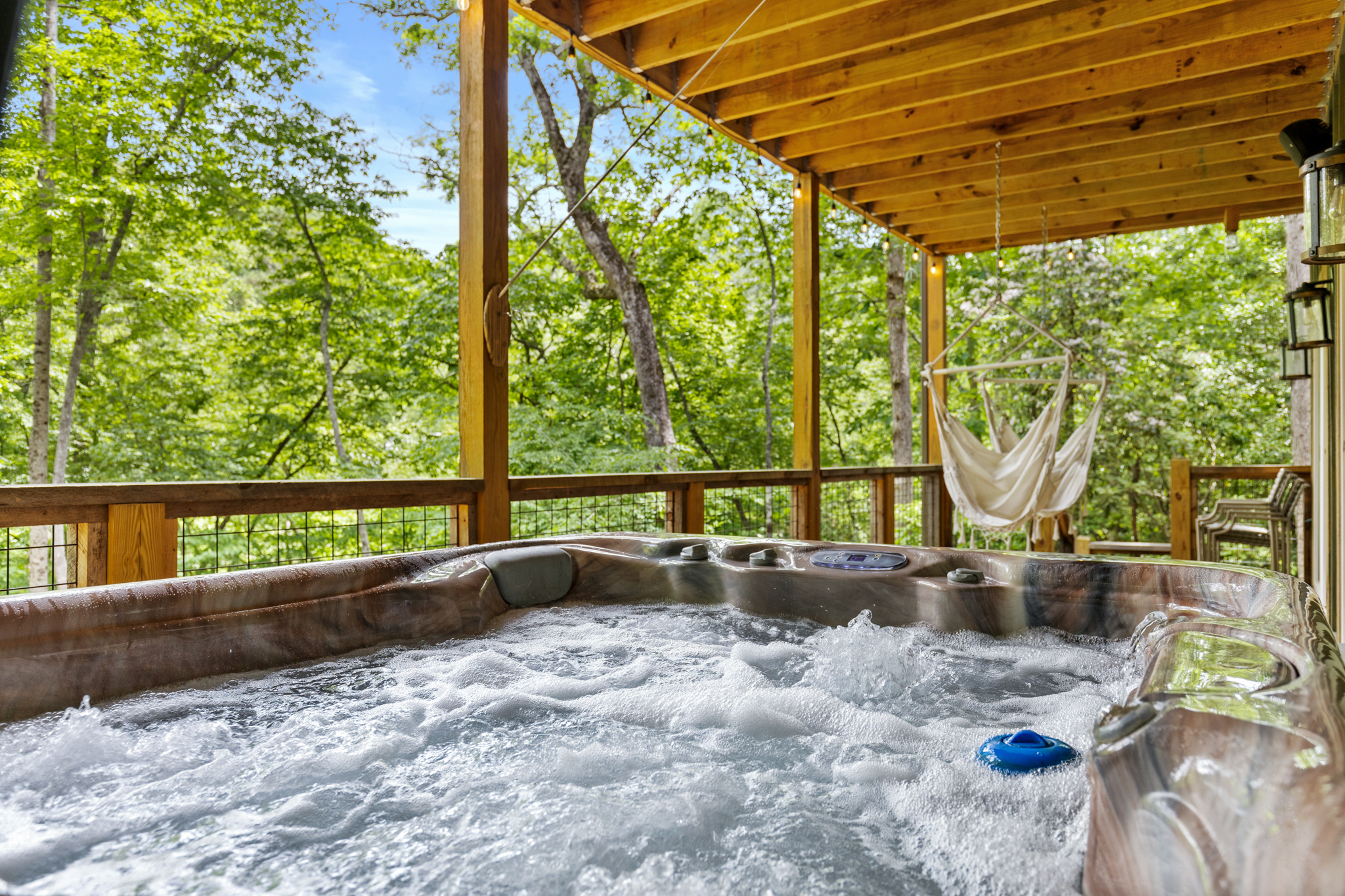 Gather outside and enjoy the backyard and river from the hot tub and porch hammocks.