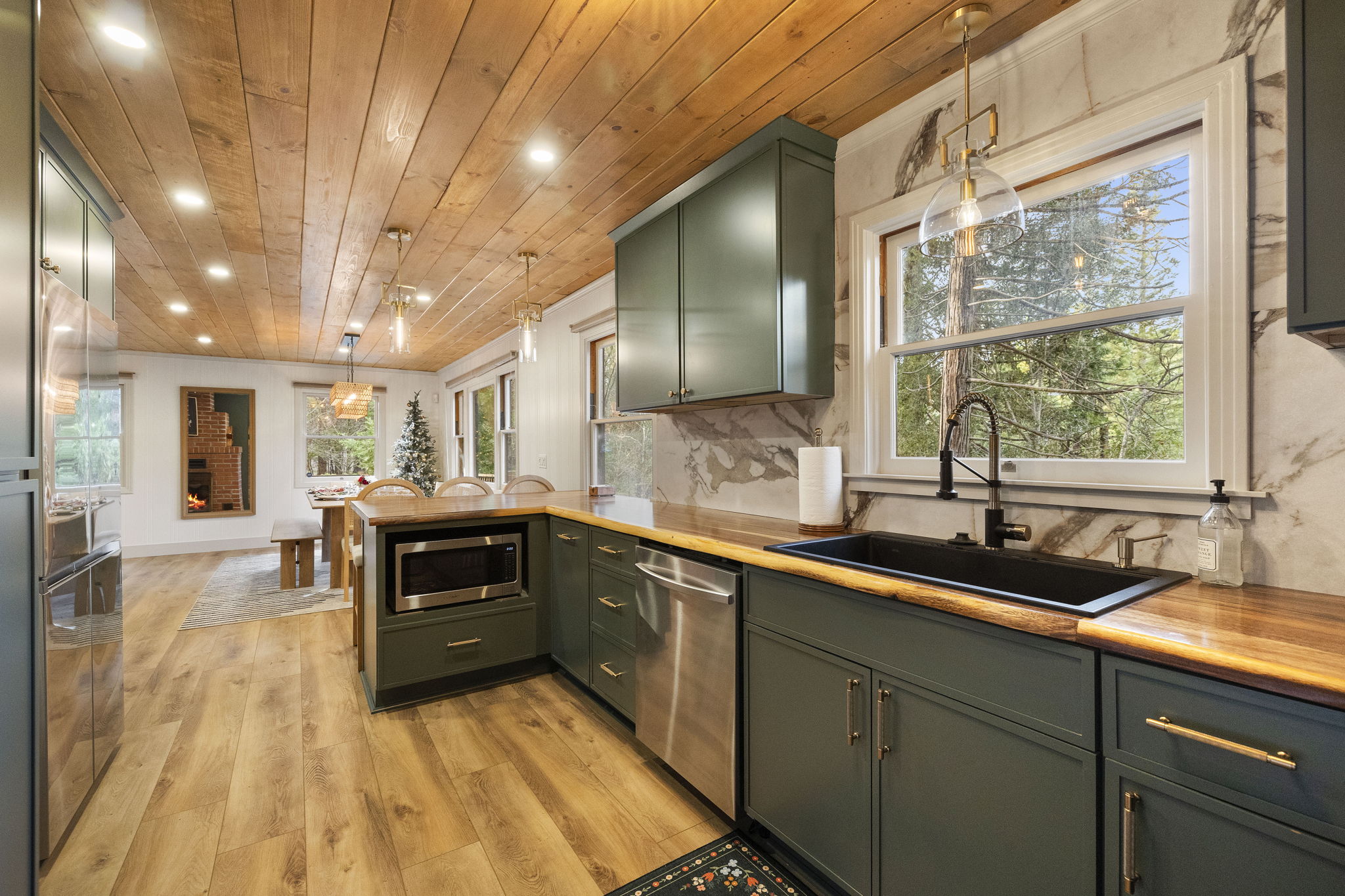 Beautiful views over the kitchen sink. Custom acacia, raw edge countertops showcase the kitchen.