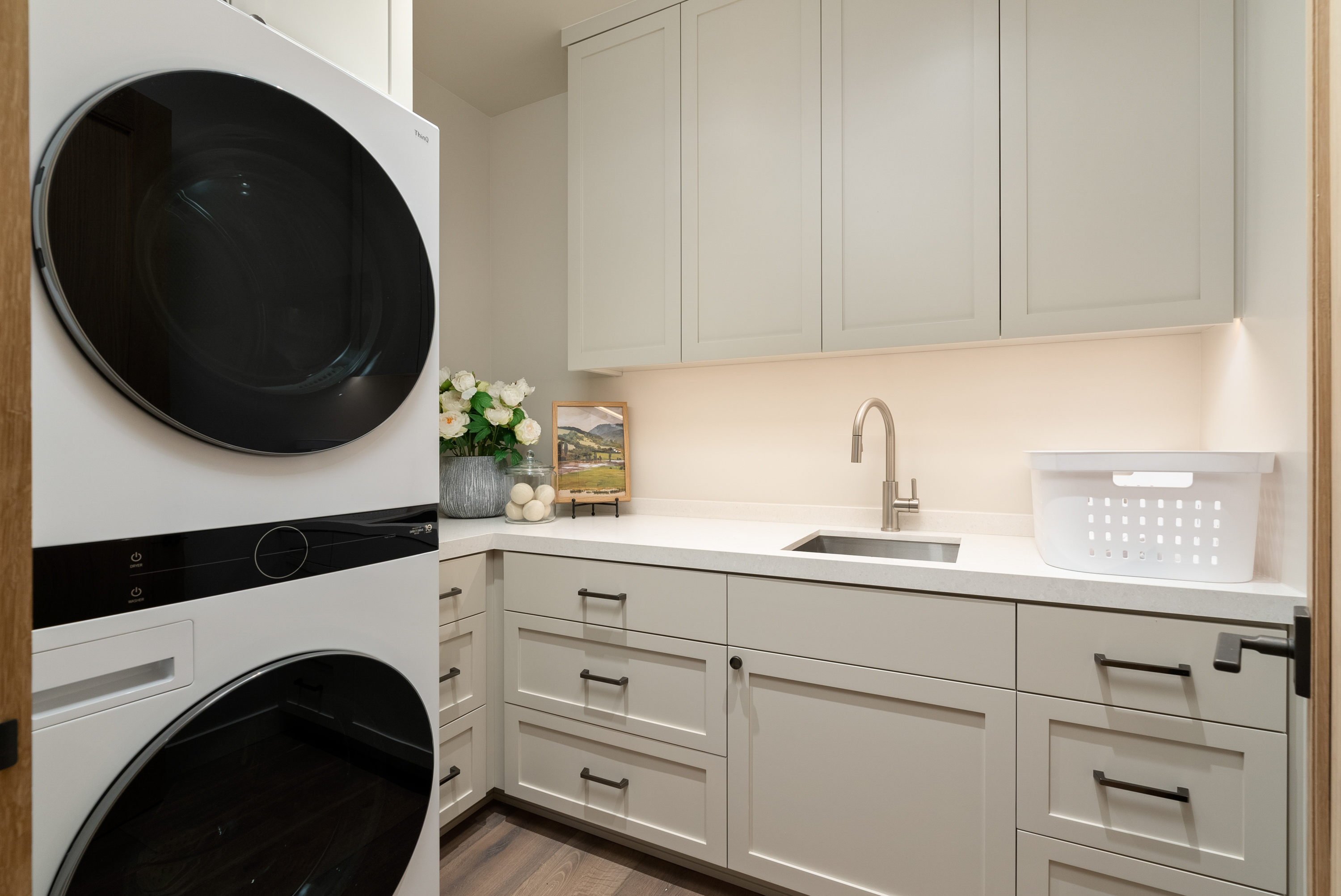 Well-equipped laundry room with sink and lots of storage